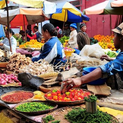 Antananarivo, Madagascar- June 18, 2016:  Vendor selling peppercorns, chillies, shallots, garlic and ginger at Analakely Market.